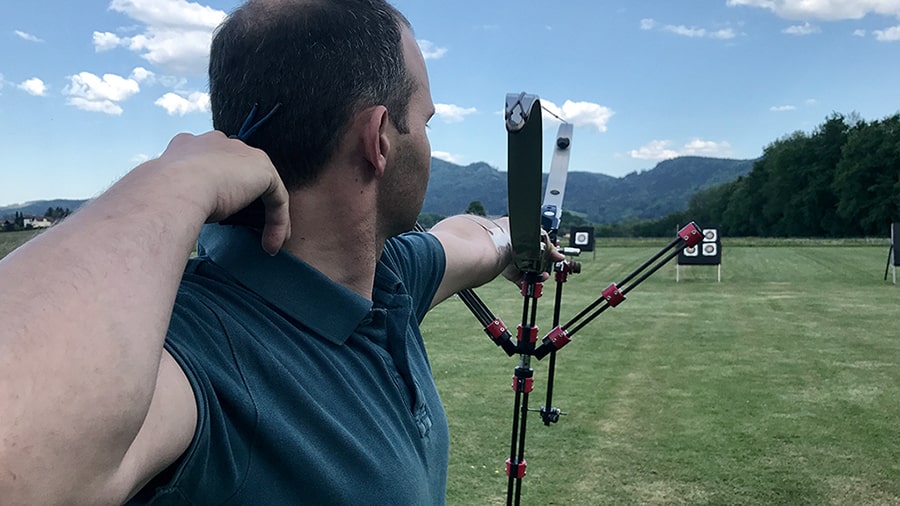 Image of a notched arrow with archery targets in the background.